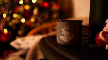 Wooden desk space with mug and xmas tree photo