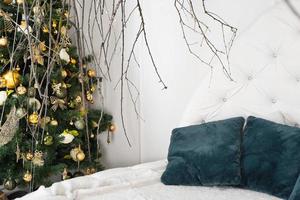 Bright white room with canopy of branches - christmas decoration photo