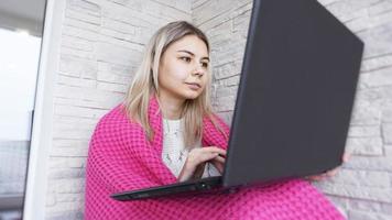 Beautiful young woman with a laptop photo