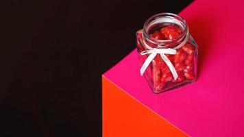 Valentine day concept. Hearts in jar with red and black background photo