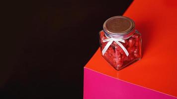 Valentine day concept. Hearts in jar with red and black background photo