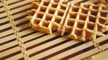 Sweet fresh Viennese waffles on rustic wooden background photo