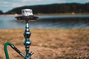 Hookah bowl stands in nature by the river close up photo