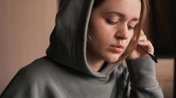 Portrait of a young girl in a hoodie and with a headset. Call center photo