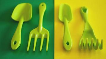 Set of green garden tools on green and yellow background photo