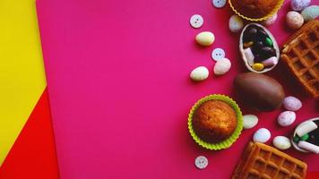 Decor Easter eggs on pink background. Flat lay photo