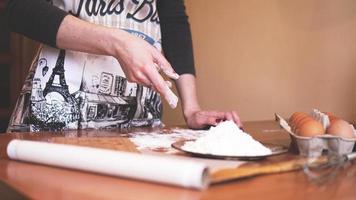 Close up scene of female hands making dough photo