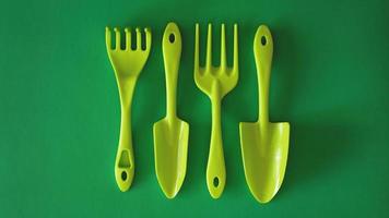 Set of green garden tools on green background photo