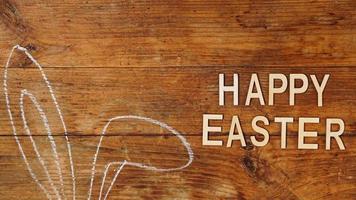 Chalk-drawn ears. Rabbit ears on a wooden background. Happy easter photo