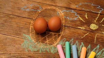Easter eggs in a basket. Drawing with colored chalk photo