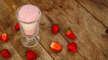 Strawberry and vanilla ice cream in a glass glass photo