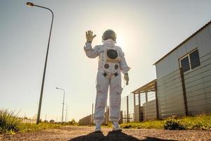 Astronaut on futuristic city background, glimpse at future photo