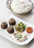 Organic falafel and hummus starter snack food mezze platter on white table photo