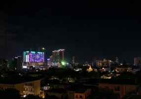 Downtown central Phnom Penh city night view in Cambodia with Naga World casino complex and Koh Pich Diamond Island skyline photo