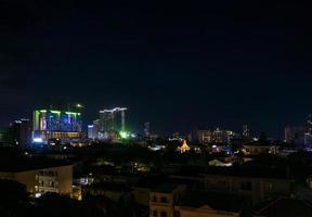 Downtown central Phnom Penh city night view in Cambodia with Naga World casino complex and Koh Pich Diamond Island skyline photo