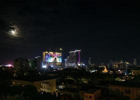 Downtown central Phnom Penh city night view in Cambodia with Naga World casino complex and Koh Pich Diamond Island skyline photo