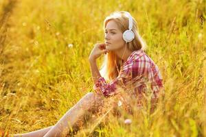 Happy girl listening to music on headphones photo