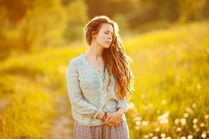 Girl with dreadlocks in a shirt photo