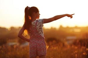 little girl points towards photo