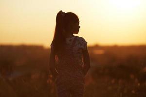 Girl stands and looks into the distance photo