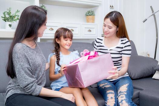 happy of family giving the gift box with daughter. photo