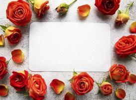 Flowers composition. Frame made of red  roses and leaves photo