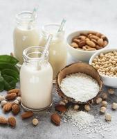 Alternative types of vegan milks in glass bottles photo