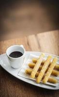 Churros and chocolate Spanish donuts pastry doughnuts with sauce breakfast snack photo