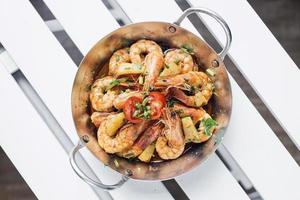 Stir fry prawns in spicy Asian food pineapple and herbs sauce photo