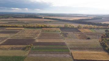 Aerial view of cereal fields after the harvest with haystack photo