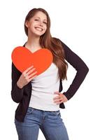 Cheerful girl with a heart in his hands photo