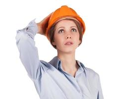 Woman in a protective helmet looking up photo
