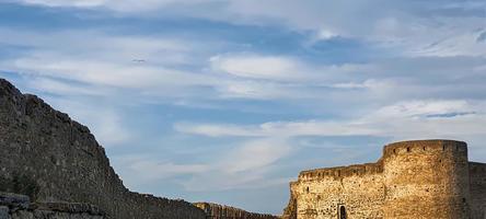 Ruined old fortress on the seashore. Blue sky. photo