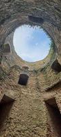 Ruined old fortress on the seashore. Blue sky. photo