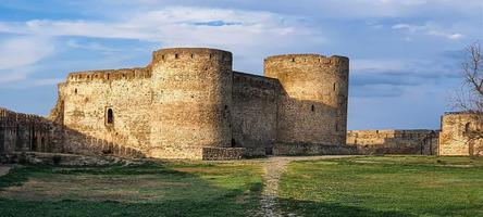 Ruined old fortress on the seashore. Blue sky. photo