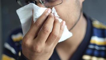 Sick man with flu blow nose with napkin video