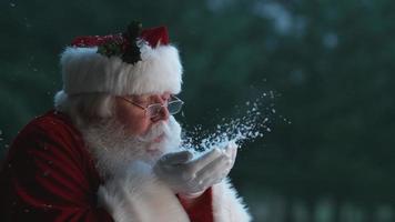 Santa Claus blowing snow from hands in slow motion, Phantom Flex 4K video