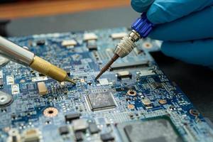 Repairing inside of hard disk by soldering iron. photo