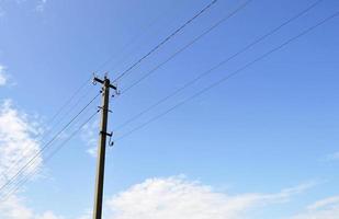 Power electric pole with line wire on colored background close up photo