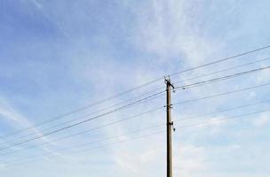 Power electric pole with line wire on colored background close up photo