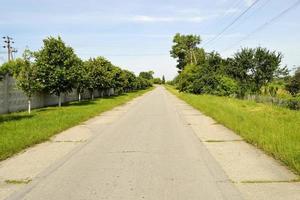 Beautiful empty asphalt road in countryside on colored background photo