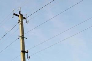 Power electric pole with line wire on colored background close up photo