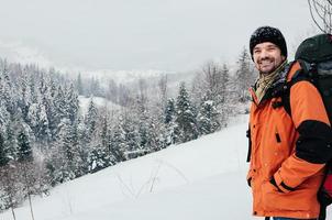 smiling tourist winter mountain forest landscape photo