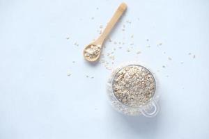 Oats flakes in a jar with spoon on table photo