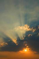 Beautiful sky with clouds and sun rays at sunset photo