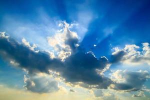 Beautiful blue sky with clouds and sun rays photo