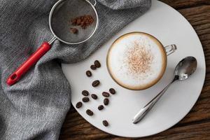 cappuccino coffee clear cup on wood background