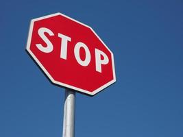 stop sign over blue sky photo