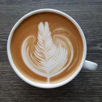 Top view of a mug of latte art coffee. photo