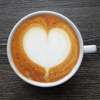 Top view of a mug of latte art coffee. photo